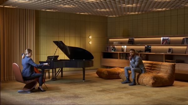 Elegant room with a woman playing a violin and a man in contemplation, surrounded by warm wooden accents and modern decor
